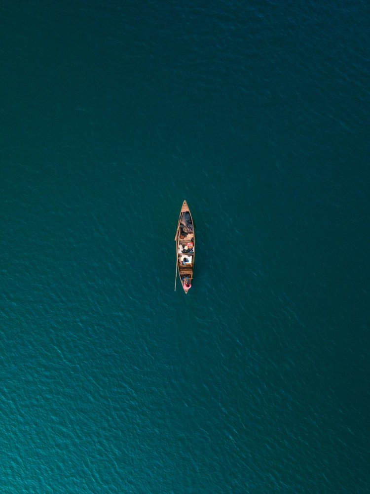 Lone Boat on Teal Water