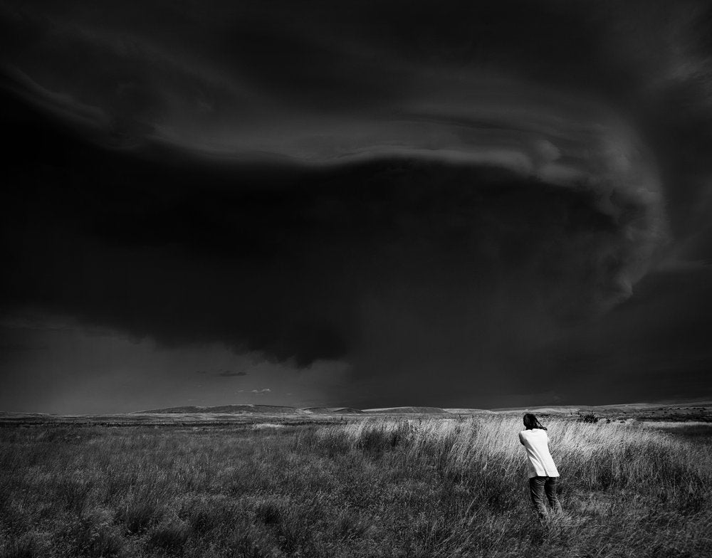 Figure Under Stormy Sky