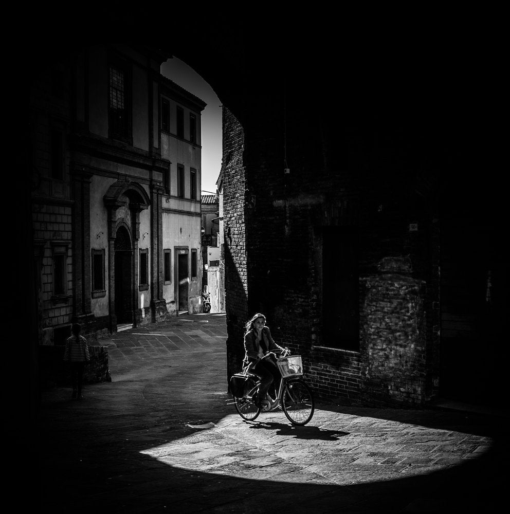 Woman Cycling Through Light