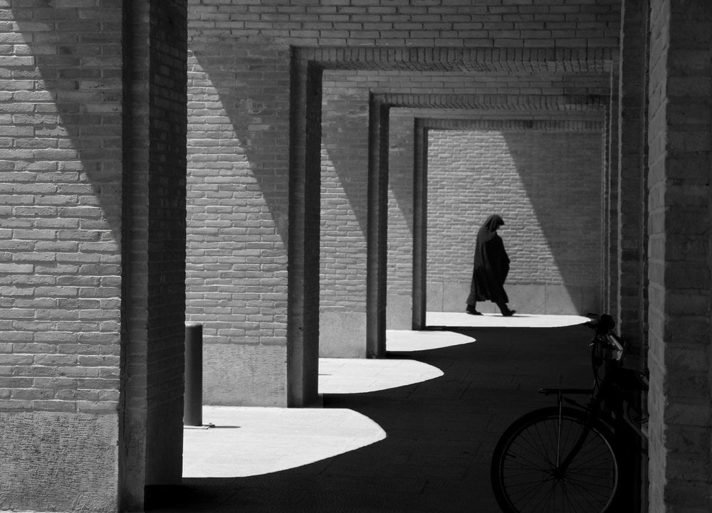 Person In Arched Hallway