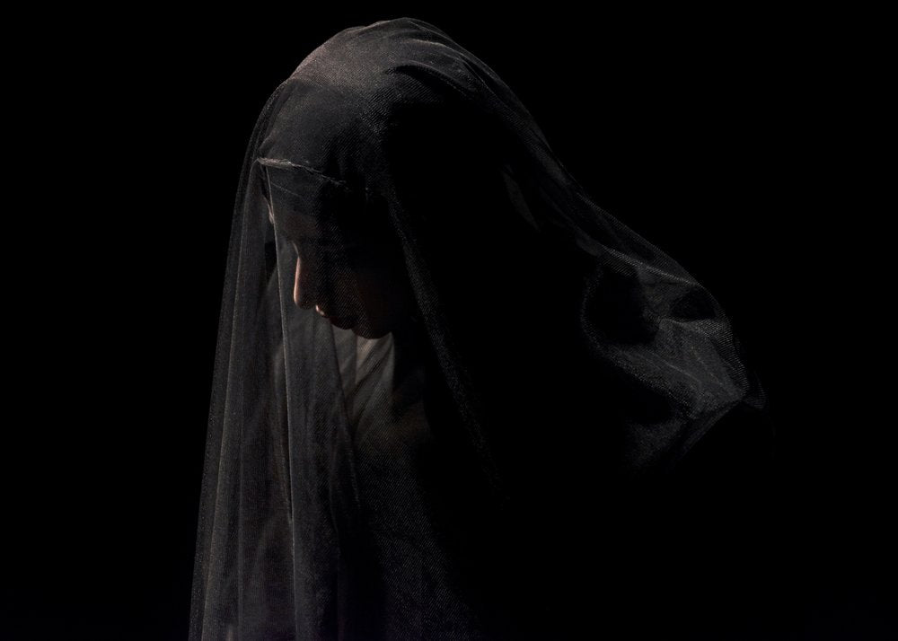 Solemn Veiled Woman