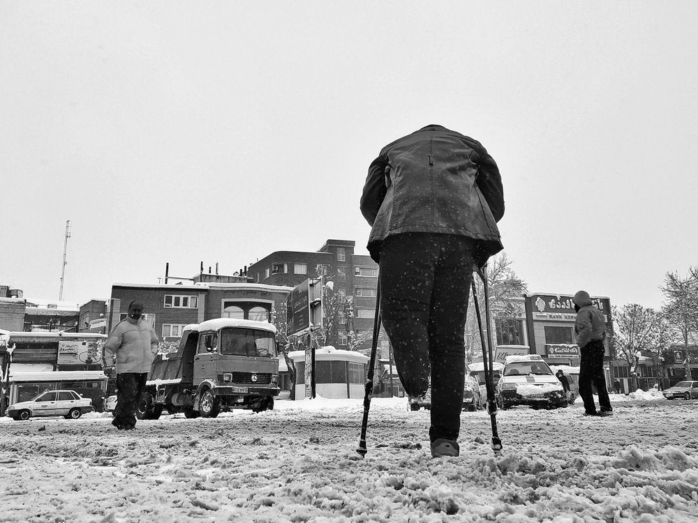 Man On Crutches In Snow