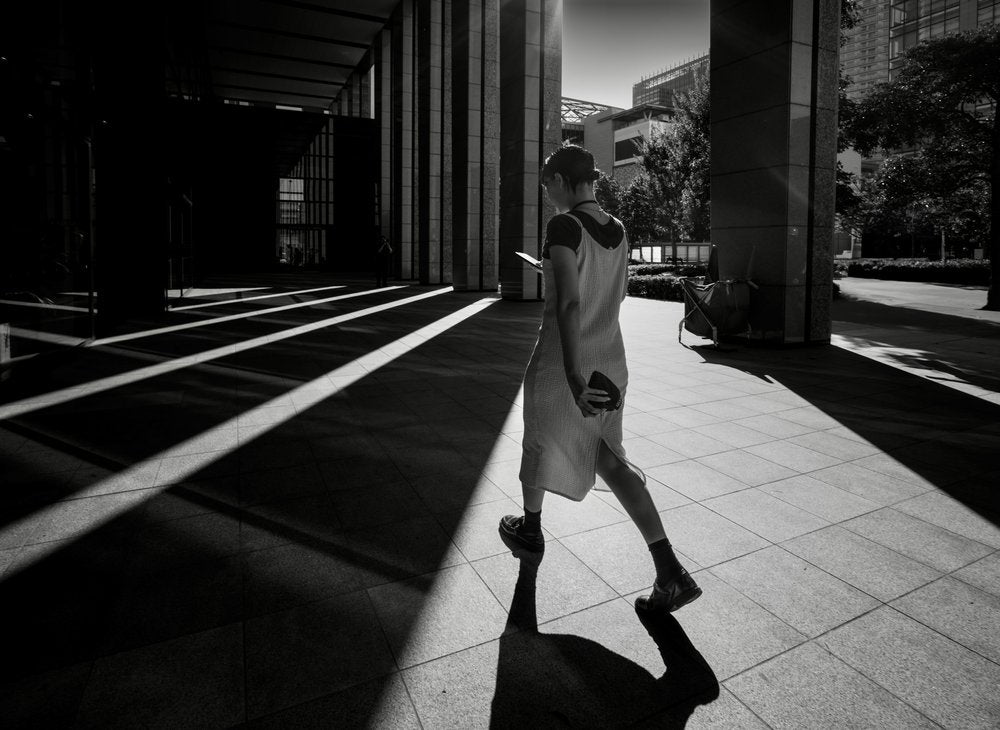 Woman in City Shadows
