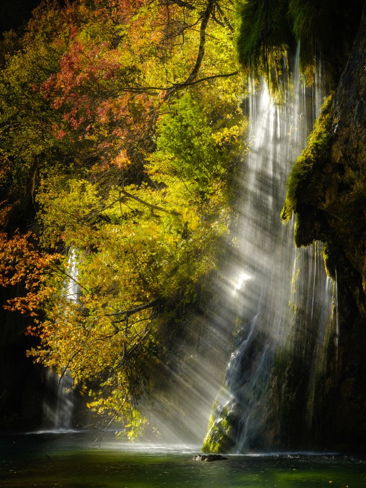 Sunlit Autumn Waterfall