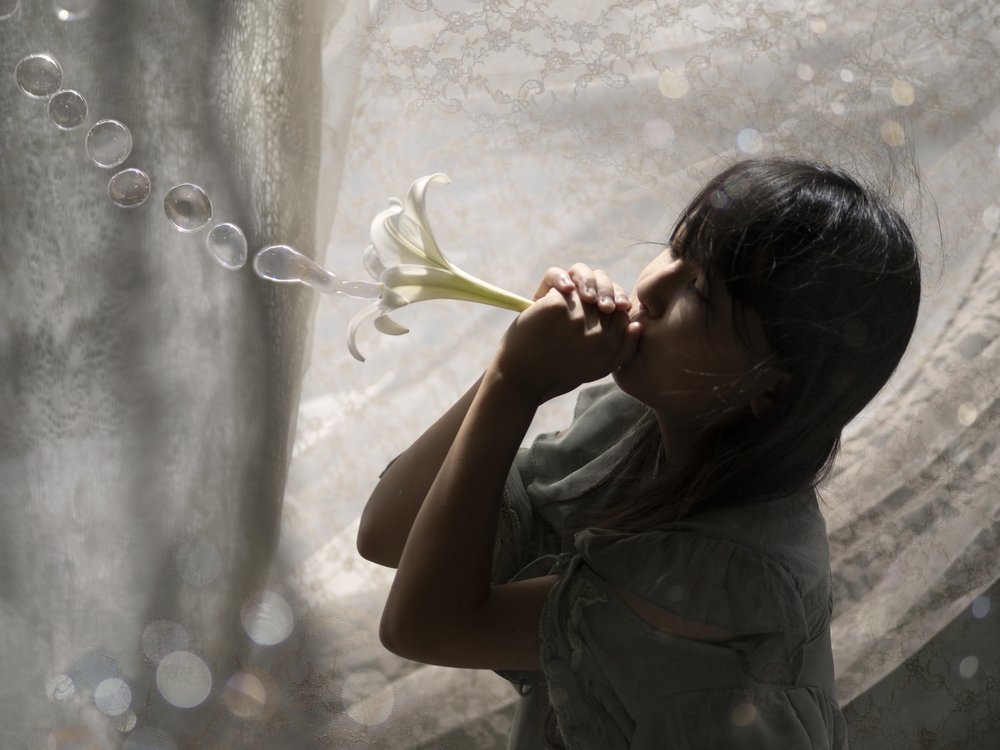 Girl Blowing Lily Bubbles