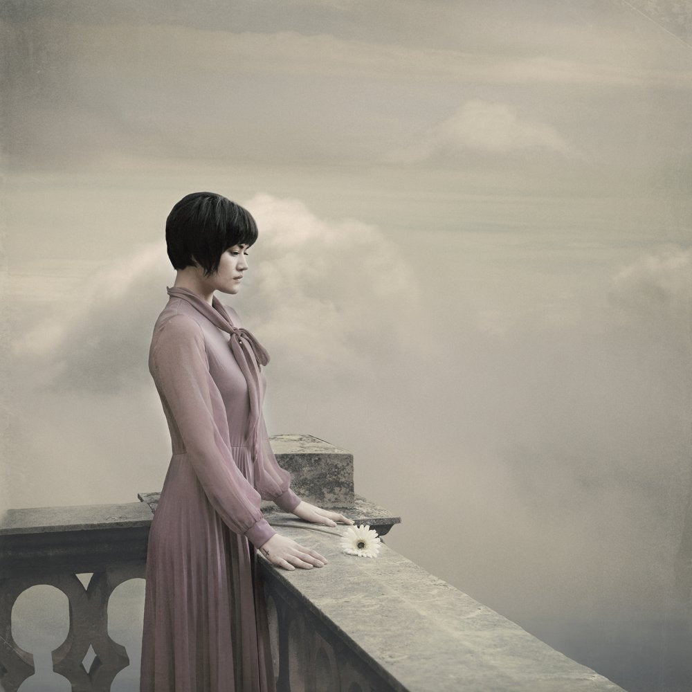 Pensive Woman Over Clouds