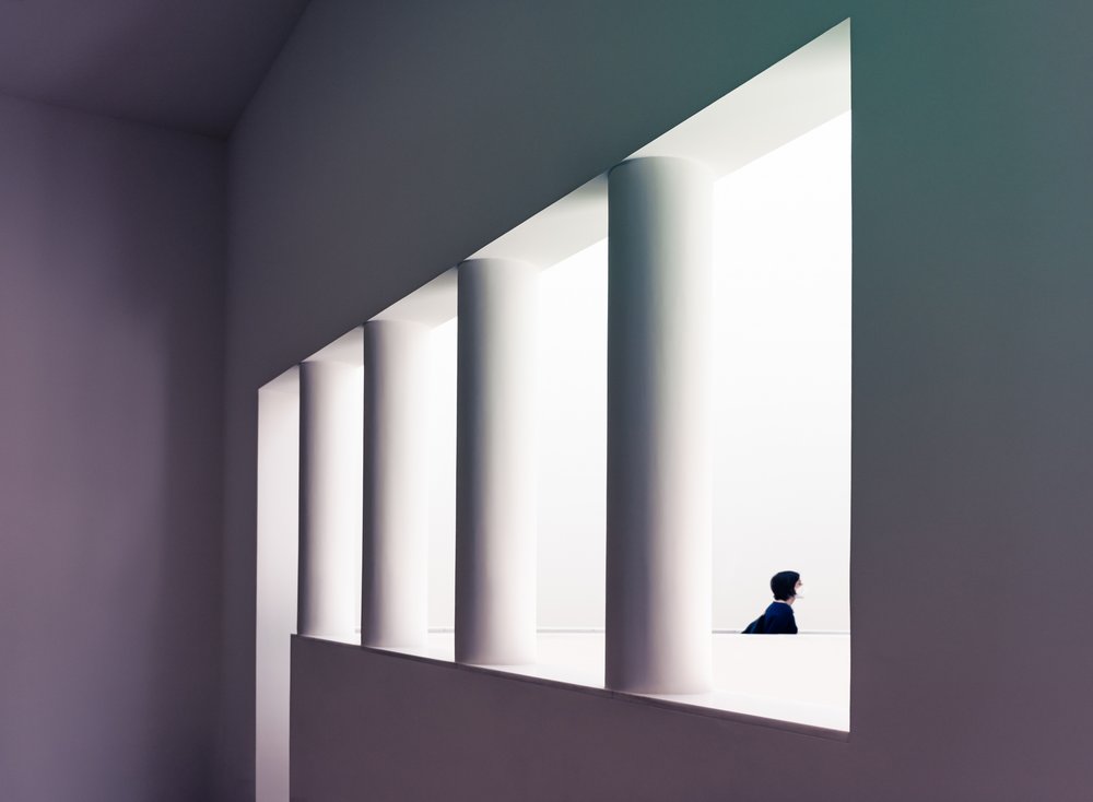 Man Framed by White Pillars
