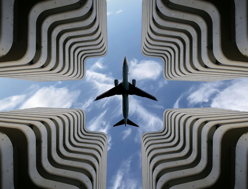 Airplane Over Urban Architecture