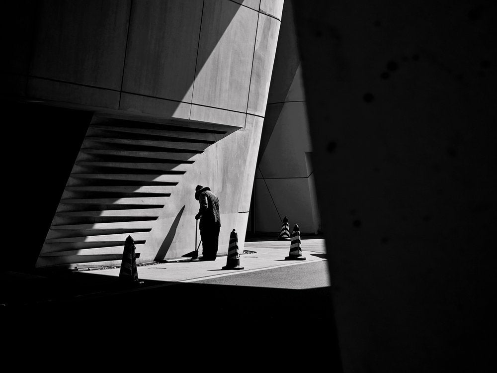 Man Sweeping Shadows