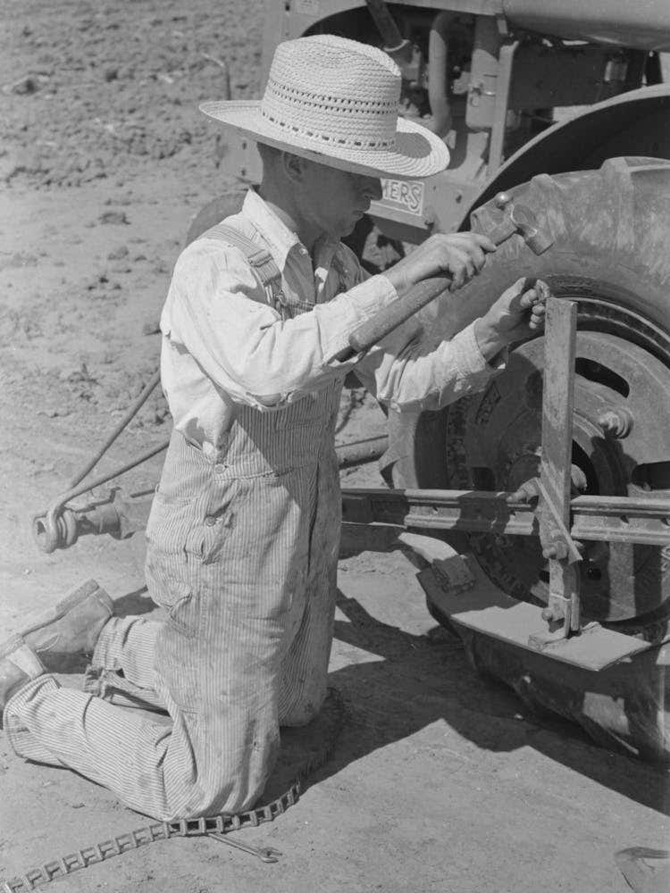 Day Laborer Repairing Link Of Chain Which Operates Planter Feed, Farm Near Ralls, Texas By Russell Lee