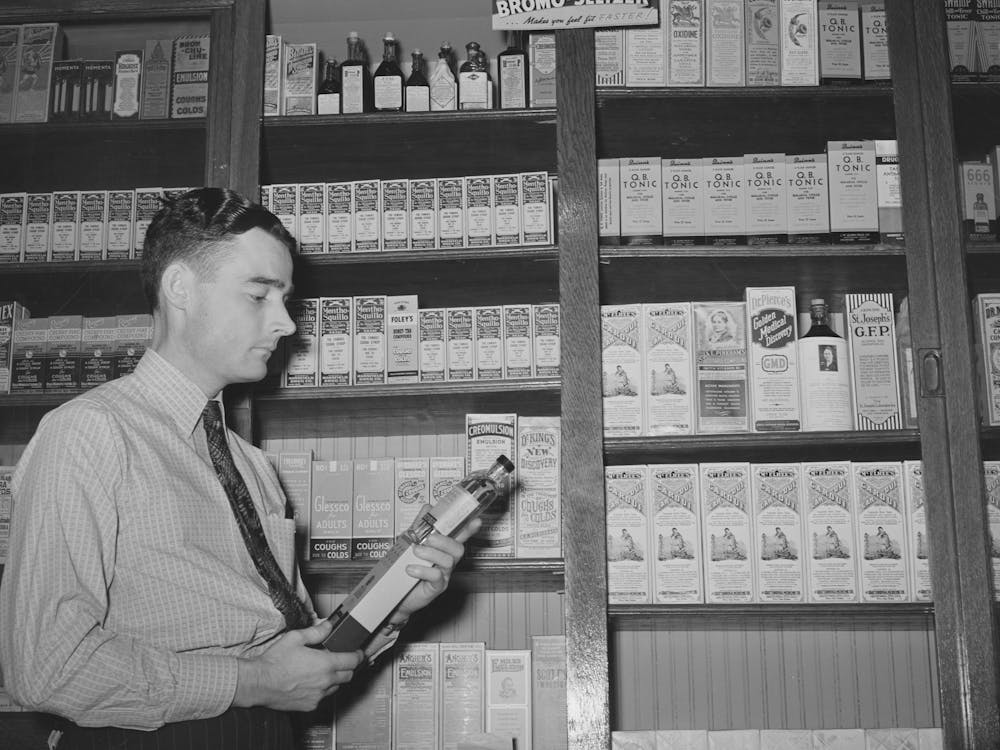 Druggist In Front Of Patent Medicine Shelf, San Augustine, Texas By Russell Lee