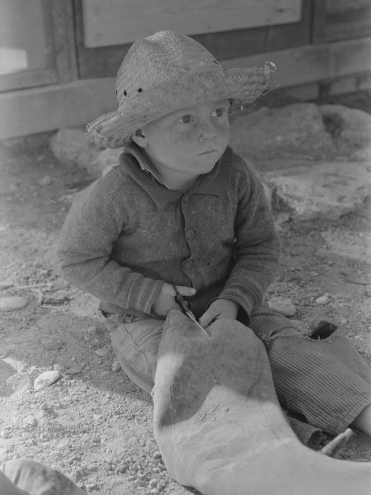 Little Boy Cutting Up Inner Tube, El Indio, Texas By Russell Lee