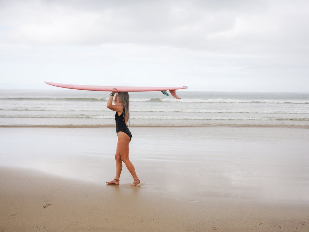 Surfer Girl On The Beach