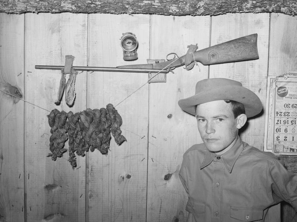 Son Of Agricultural Day Laborer With His Twenty Two Caliber Rifle And Home Cured Tobacco, Mcintosh County, Oklahoma