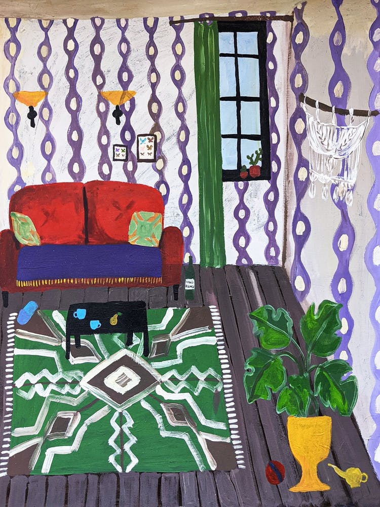 A room with a red sofa and a green carpet