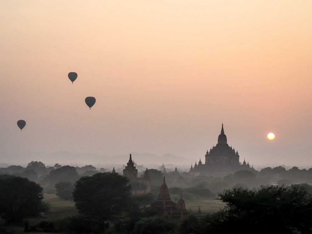Hot Air Balloons Floating In Myanmar Foggy Sunset