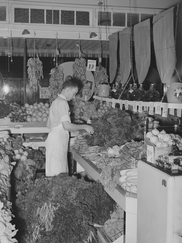 Arranging Vegetables At Retail Grocery, San Angelo, Texas By Russell Lee