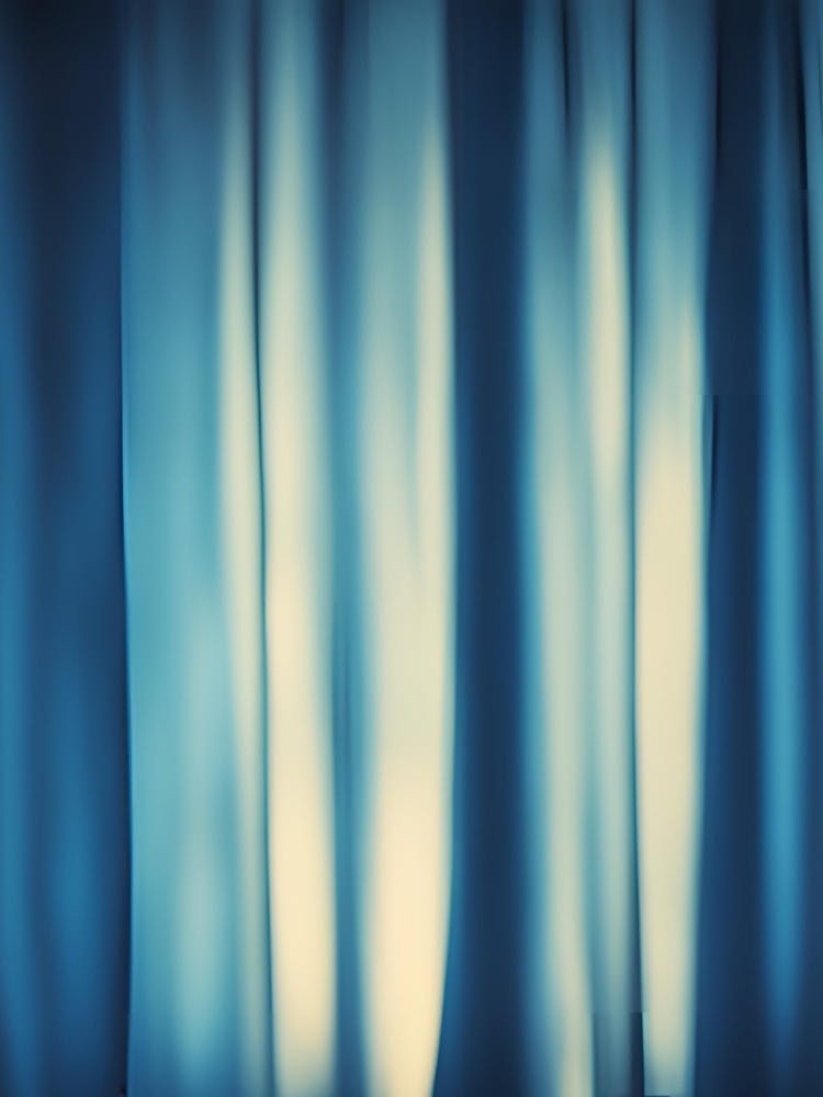 Behind the blue curtain