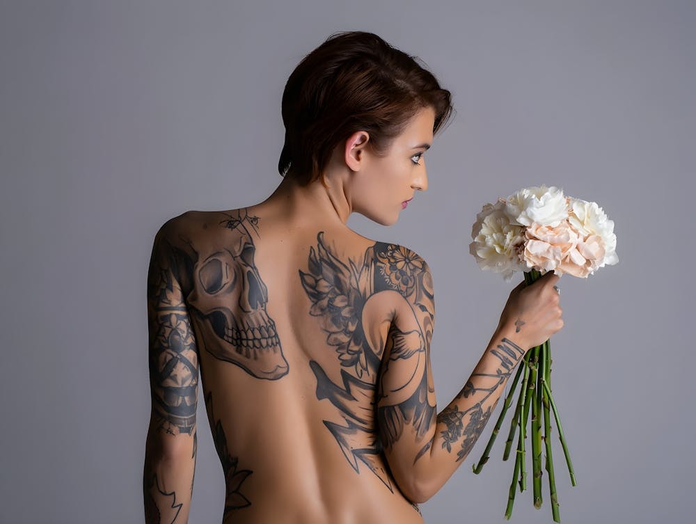 Tattooed Figure Holding Flowers: Artistic Portrait with Symbolic Ink and Serenity