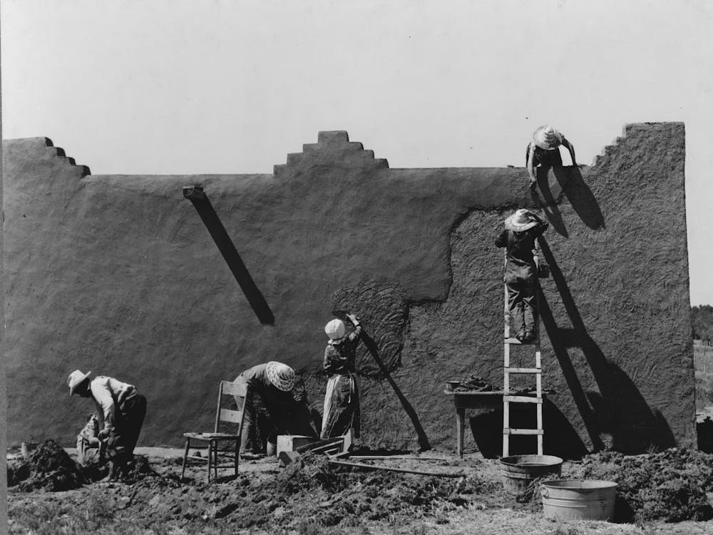 Spanish American Women Replastering An Adobe House, This Is Done Once A Year, Chamisal, New Mexico By Russell