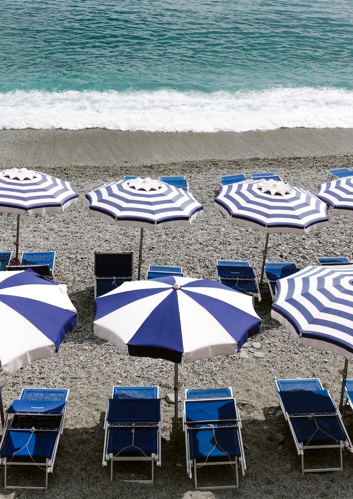 Blue Sunbeds On The Beach Of Monterosso Italy