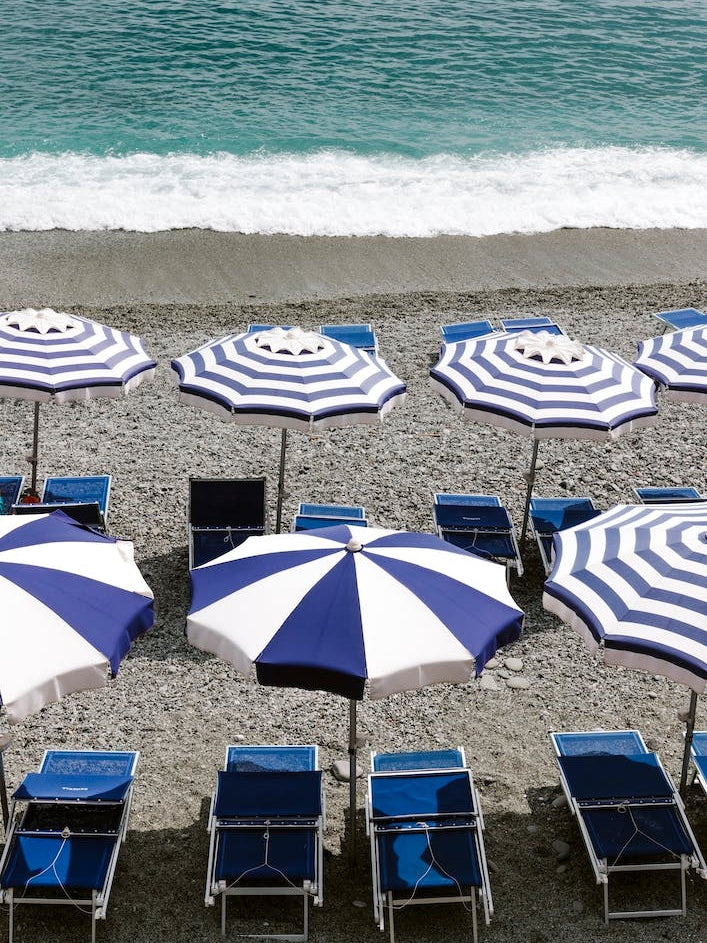 Blue Sunbeds On The Beach Of Monterosso Italy