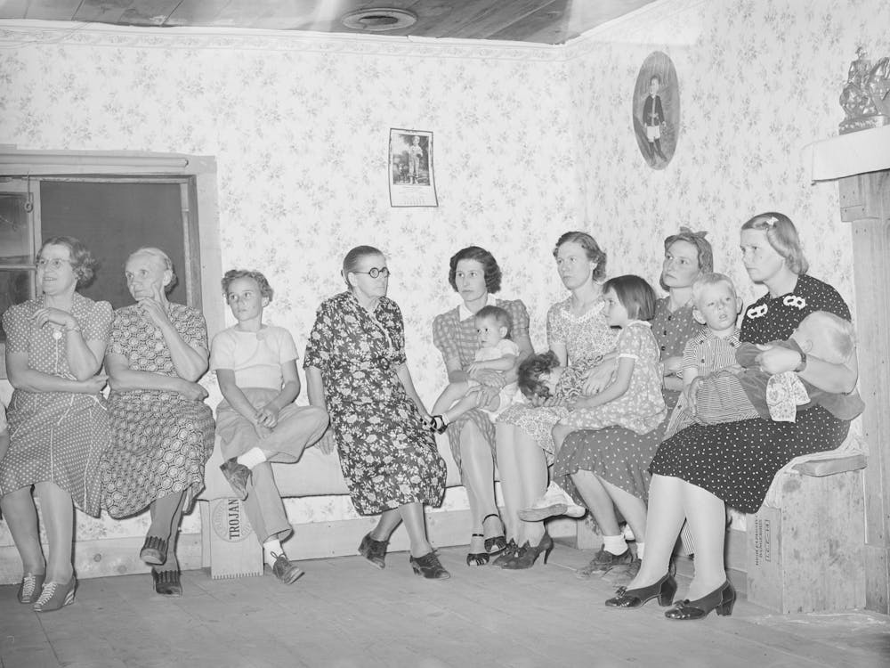 Spectators At The Square Dance, Women And Small Children Sit On One Side Of The Room, The Men And Older Boys On The