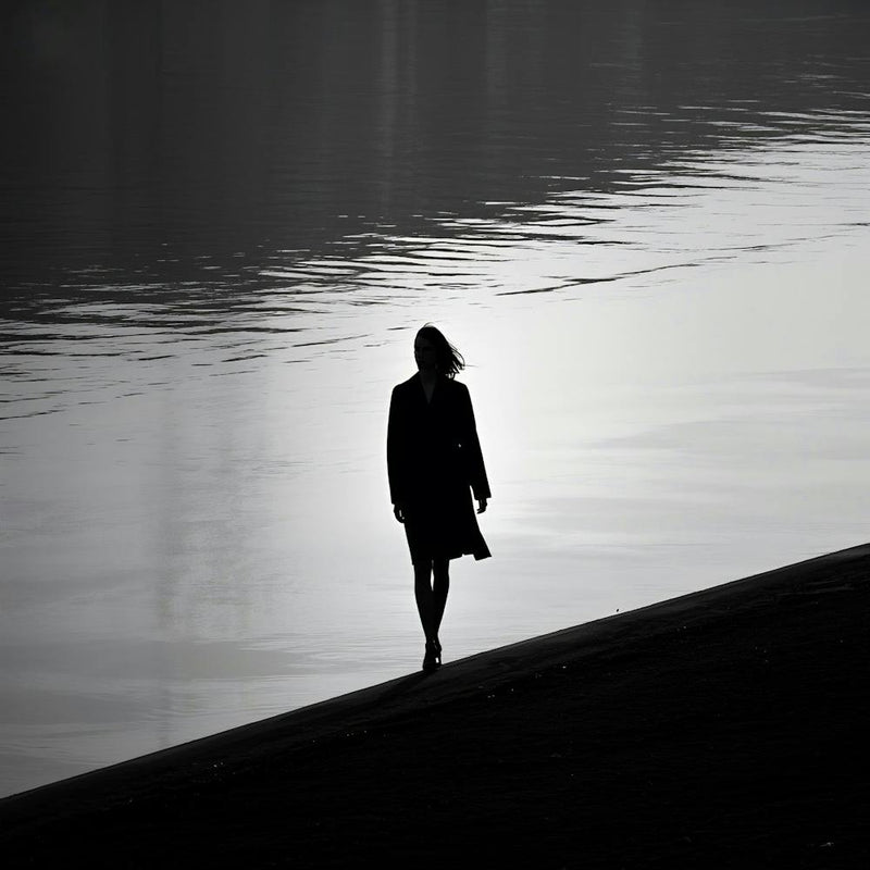 Silhouette Of A Woman Walking By The Water