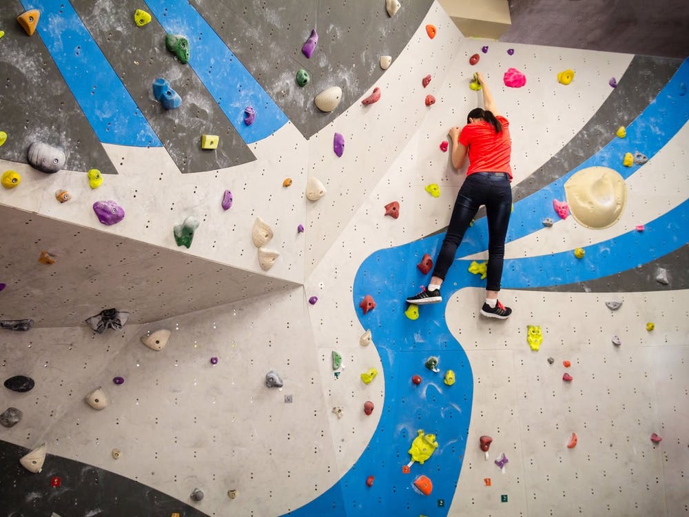 Active Young Climber Woman Climbing On Indoor Climbing Wall