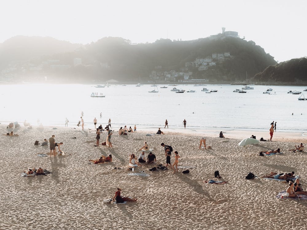 People In Sunshine On The Beach St Sebastian, Spain