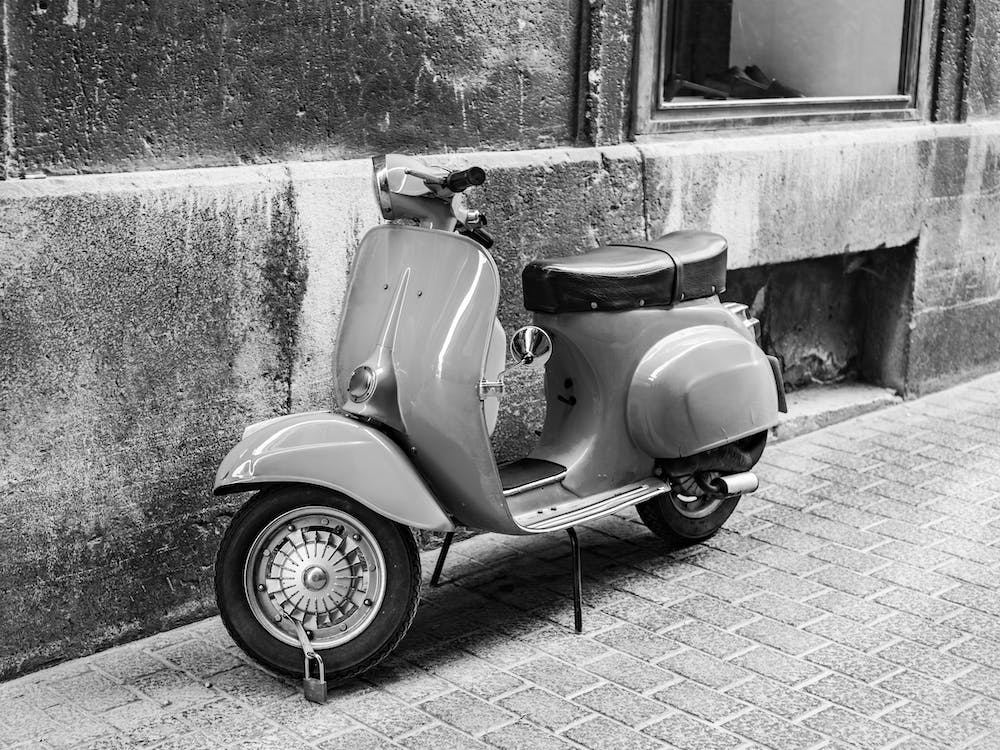 Vintage scooter parking at alley of old mediterranean town