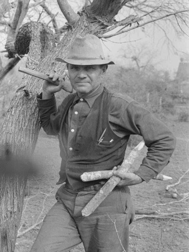 White Migrant Worker With Hatchet And Stakes To Be Used In Setting Up New Camp Near Harlingen, Texas By Russell