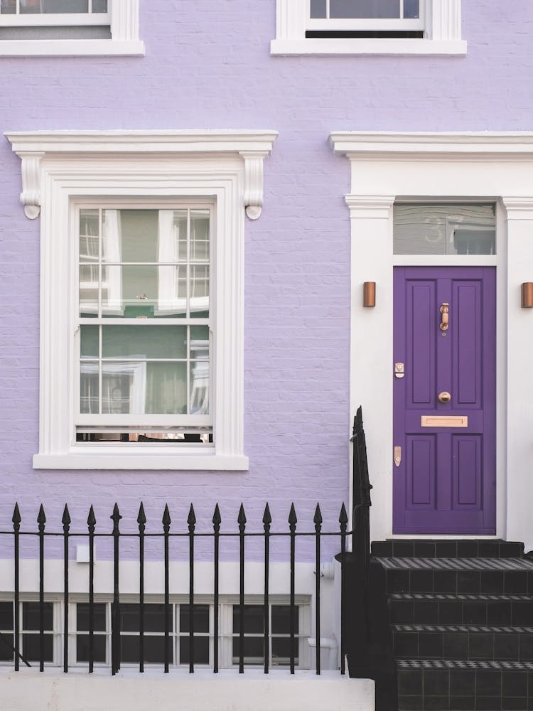 London, England I Front of a typical purple Notting Hill house with colorful brick architecture photography with minimalist geometric street photography at the retro vintage British vibrant mauve door