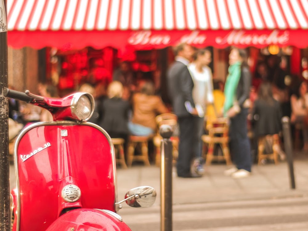 Red Vespa And Bistro In Paris
