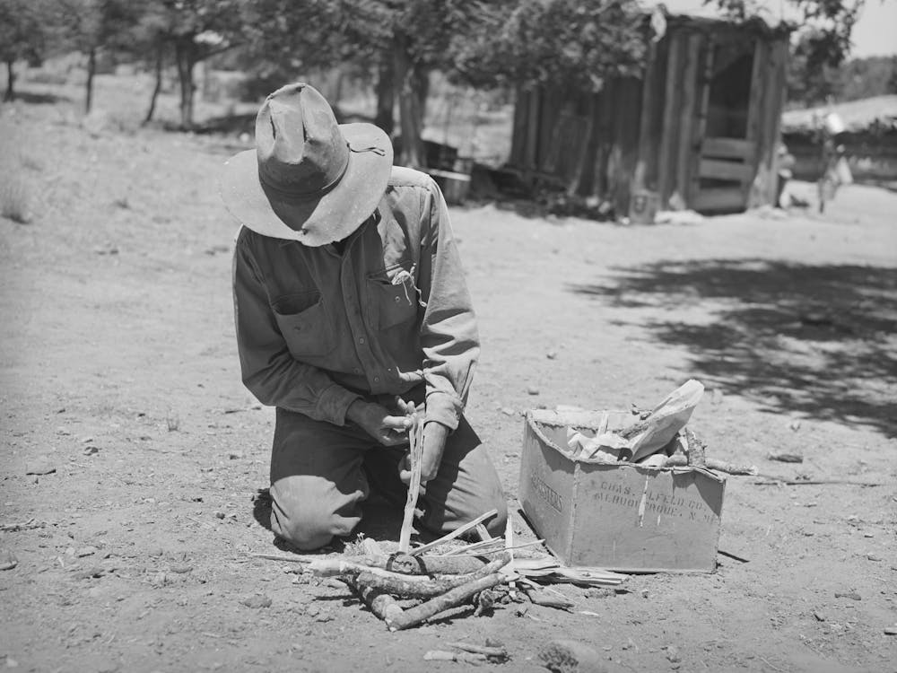 Faro Caudill Building A Fire To Cook Dinner While He Moves His Dugout, Pie Town, New Mexico By Russell Lee