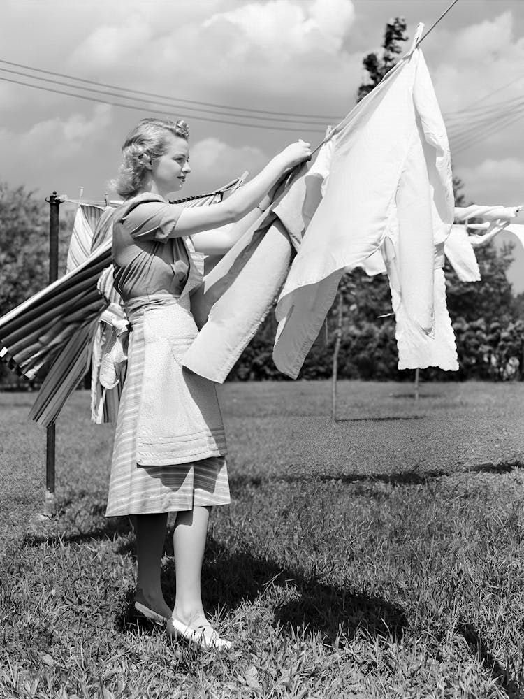 Dame beim Wäscheaufhängen an der Wäscheleine, Vintage Schwarz-Weiß Altes Foto