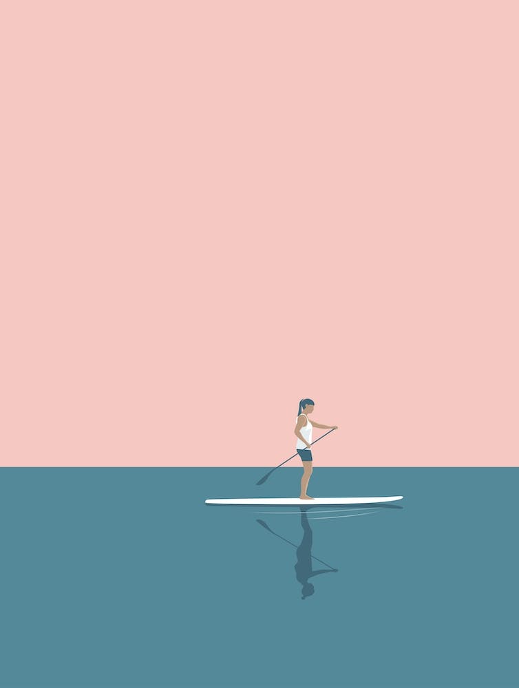 Minimal paddle boarding woman in pink