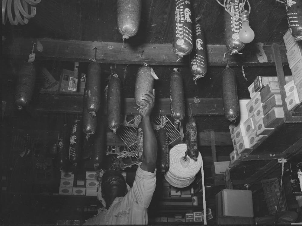 Employee Reaching For Baloney In General Store, Jarreau, Louisiana By Russell Lee