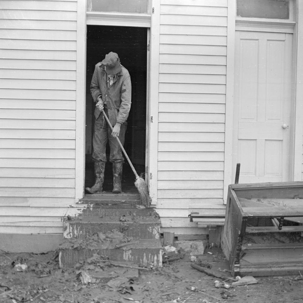 Man Sweeping Mud Off The Front Steps Of His House After Flood, Posey County, Indiana By Russell Lee