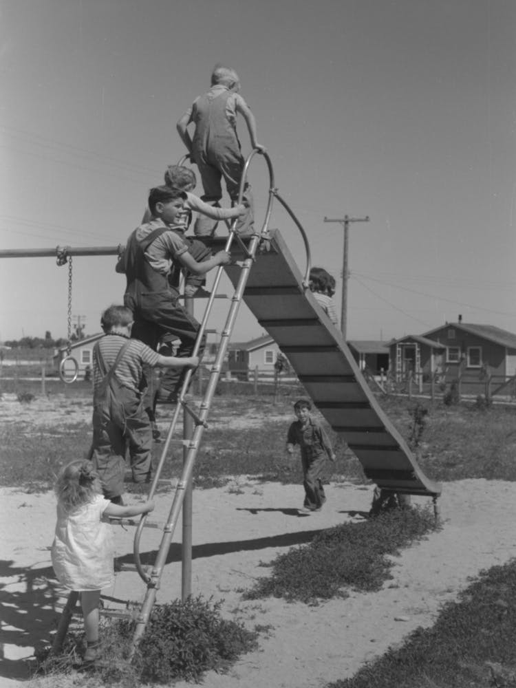 Children Playing On Slide At Fsa (Farm Security Administration) Labor Camp, Caldwell, Idaho By Russell Lee