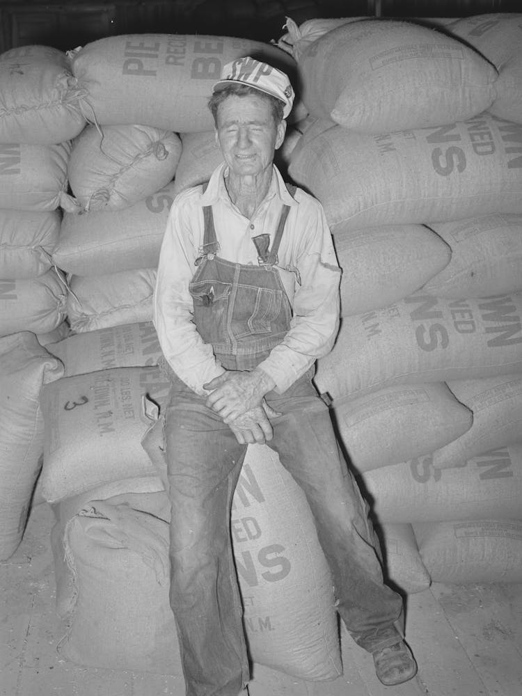 Mr, Craig, First And Foremost Citizen Of Pie Town, New Mexico, He Is Sitting On Sacks Of Pinto Beans, While He Owns