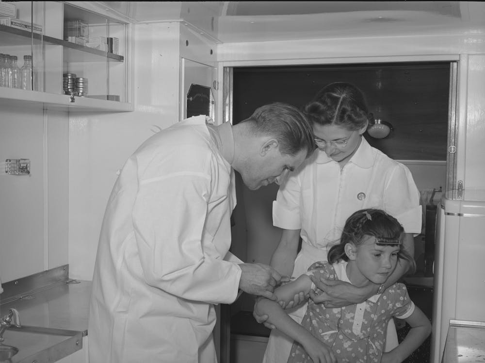 Doctor And Nurse With Little Girl In Trailer Clinic At The Fsa (Farm Security Administration) Migratory Labor Camp