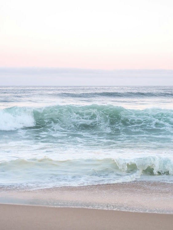 Pastel pink sunrise at Praia da Adraga Portugal - summer beach nature and travelphotography by Christa Stroo Photography