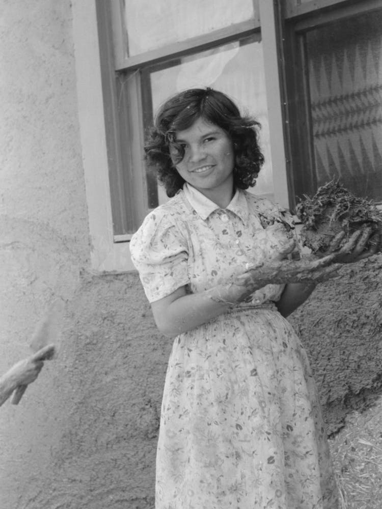 Spanish American Girl With Handful Of Adobe Plaster, Chamisal, New Mexico By Russell Lee
