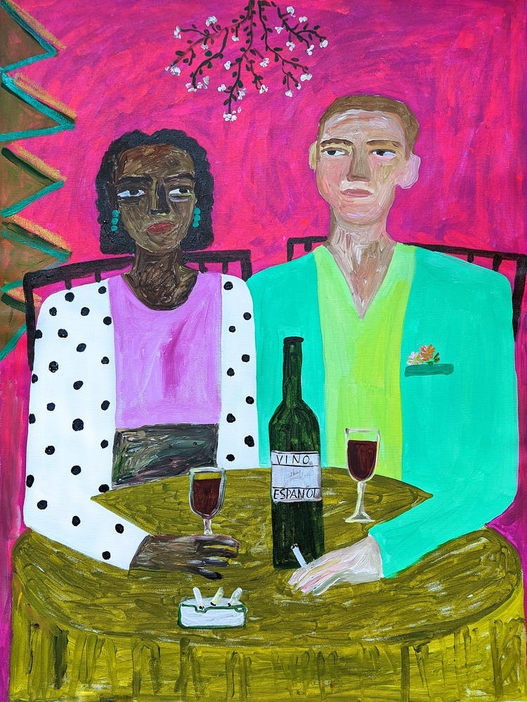 A couple of people at a table in a cafe drinking wine