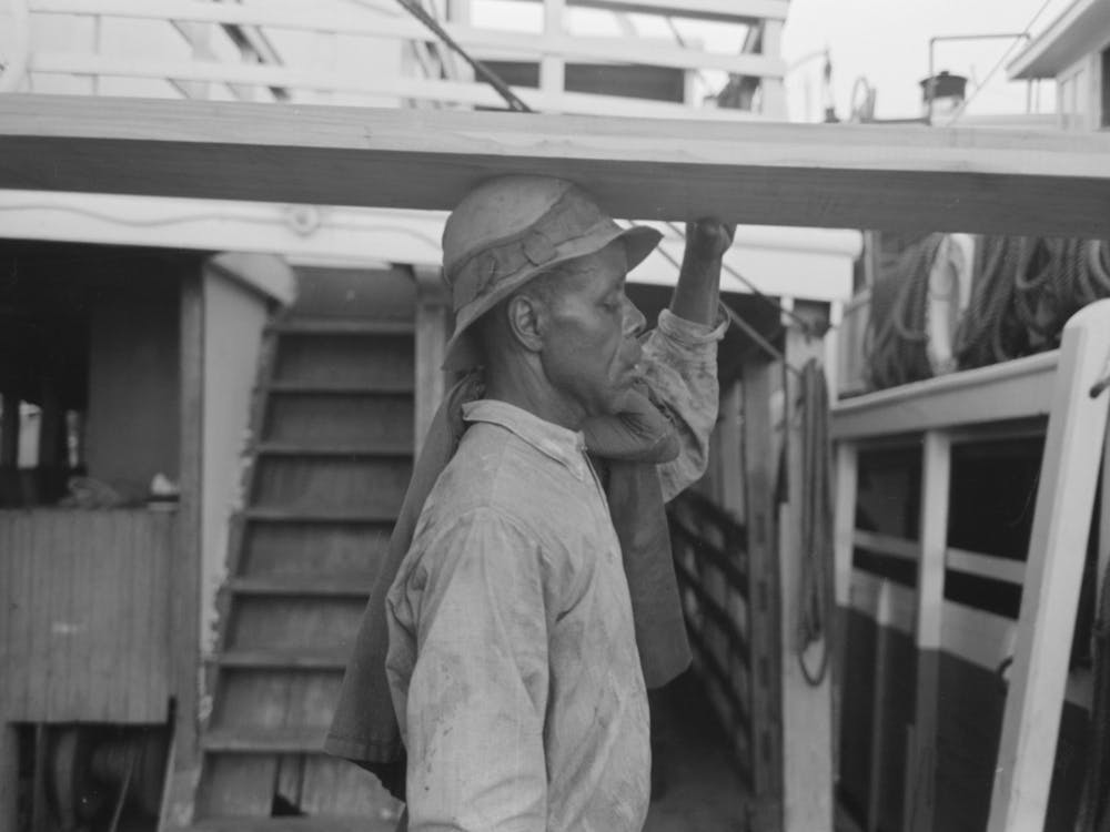 Stevedore Carrying Lumber On His Head, New Orleans, Louisiana By Russell Lee
