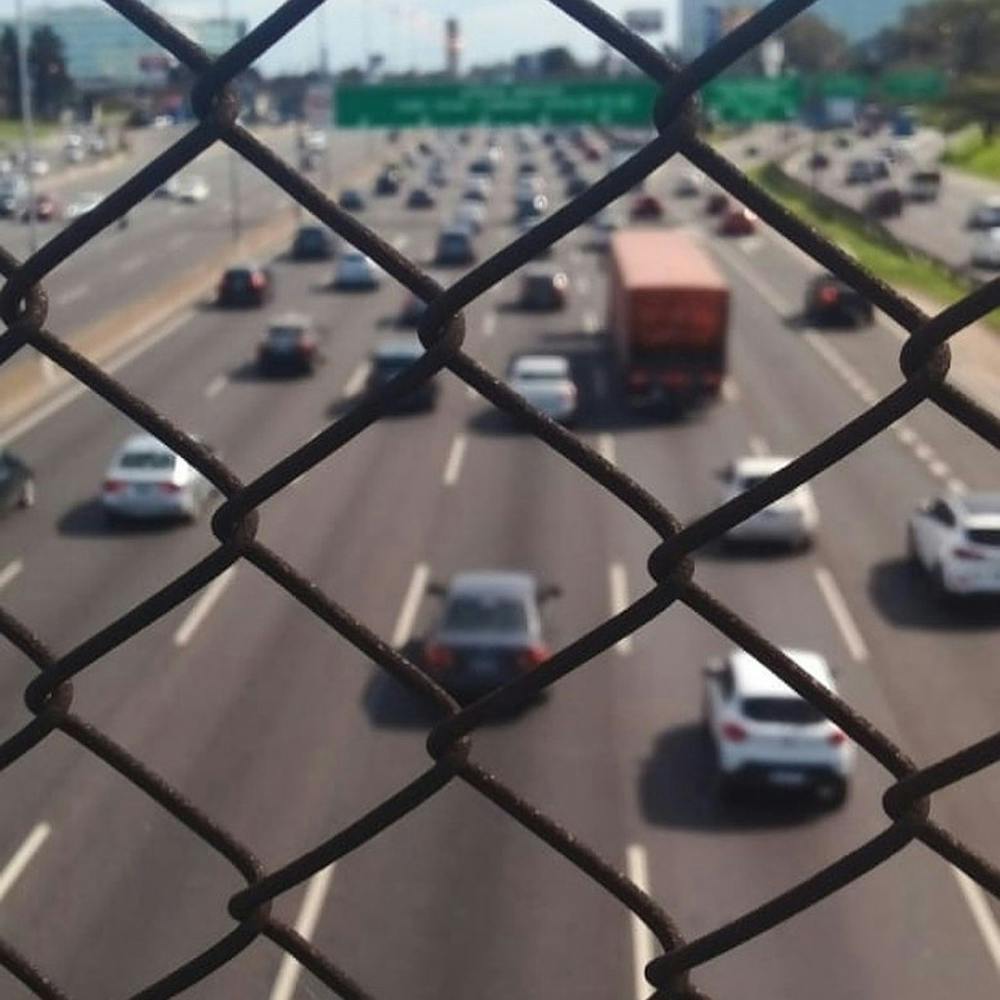 Traffic Through A Chain Link Fence
