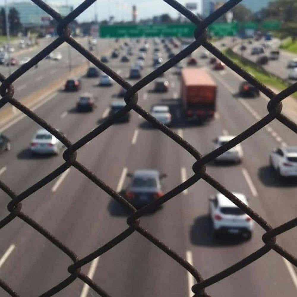 Traffic Through A Chain Link Fence