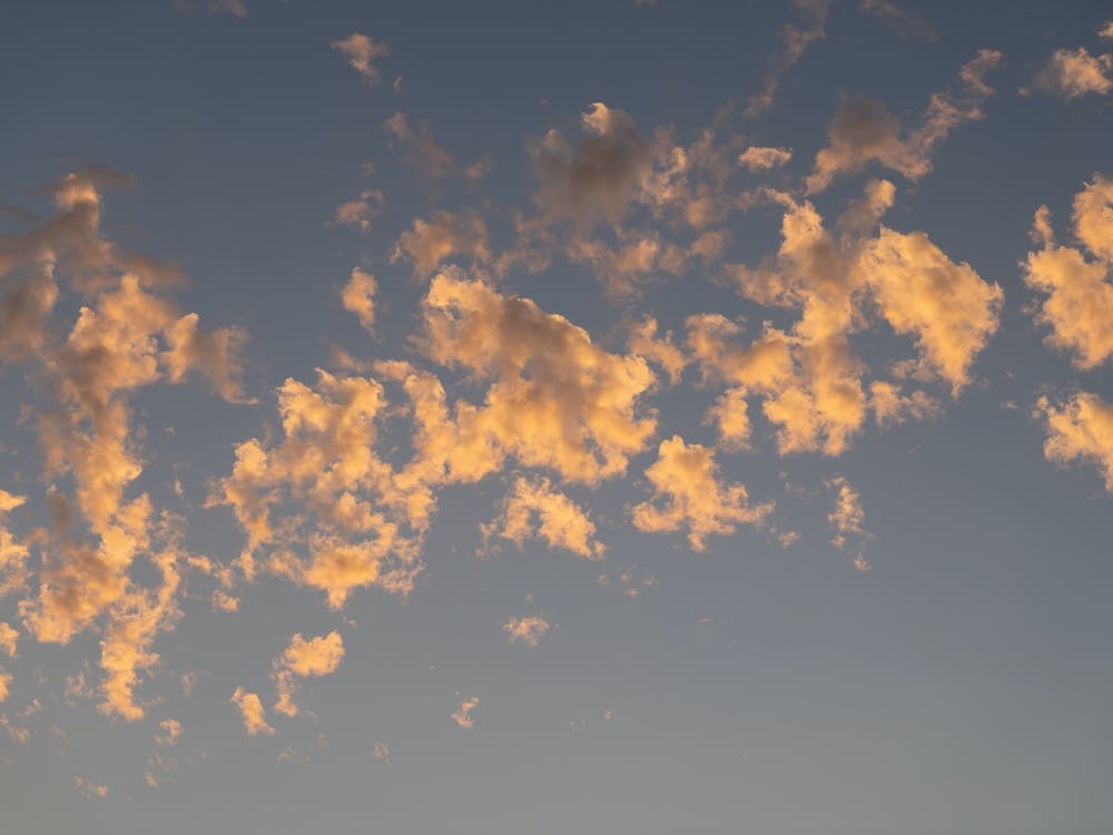 Scenic sunset clouds in pale blue sky 2