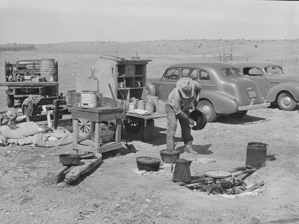 Camp Cook At Work With Chuck Wagon In Center And Truck For Carrying Bed Rolls At Left, Cattle Ranch Near Marfa, Texas By